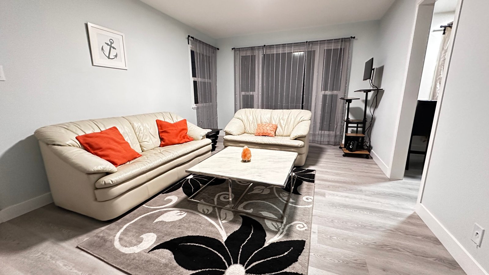 Second furnished Los Angeles living area with sofa and work-friendly layout