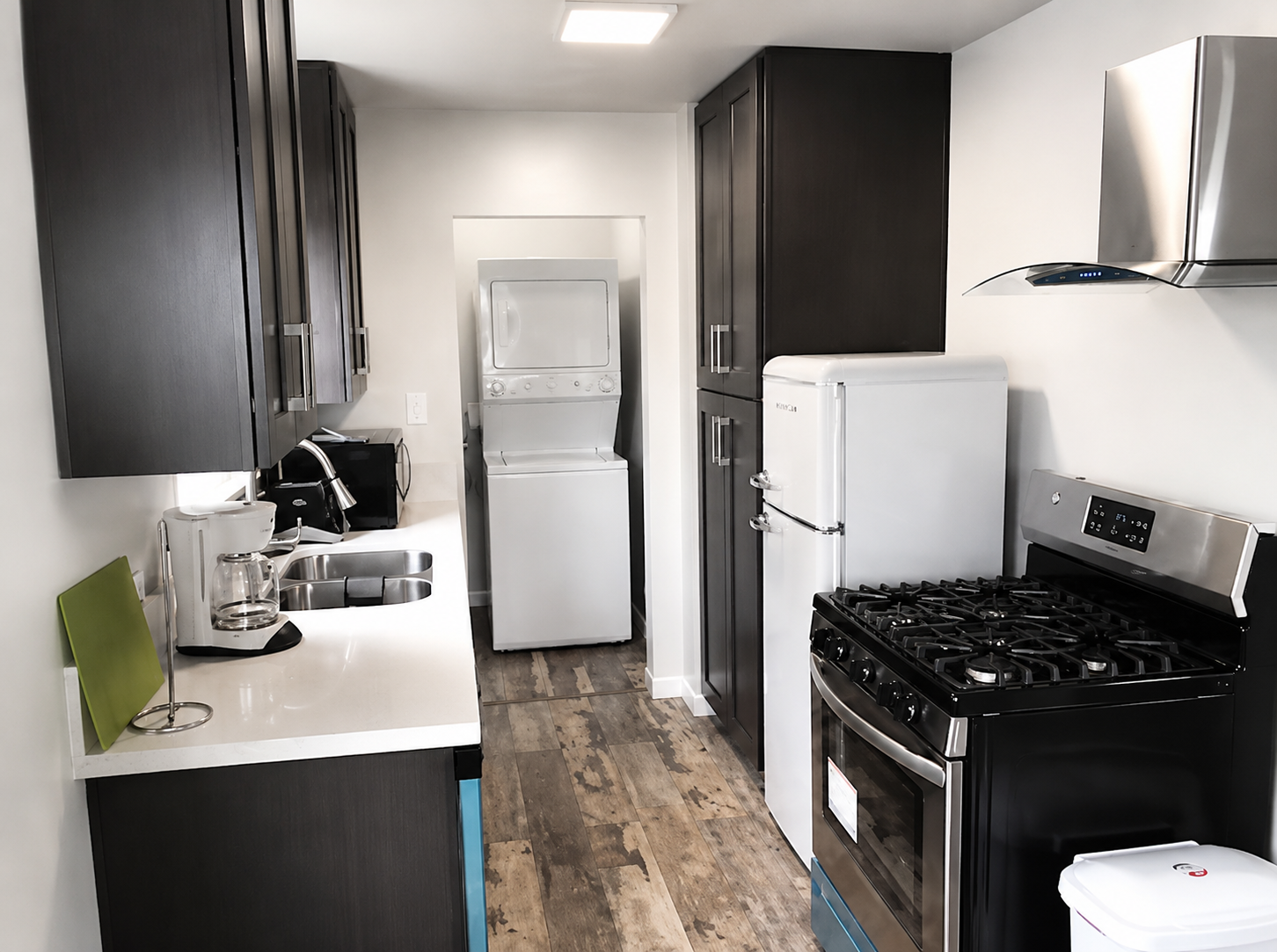 Furnished apartment kitchen with full-size appliances and laundry