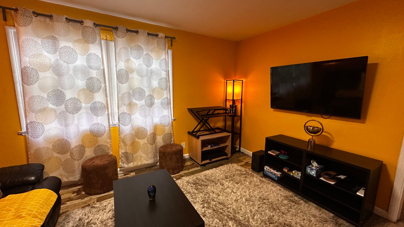 Colorful furnished Los Angeles living room with media setup